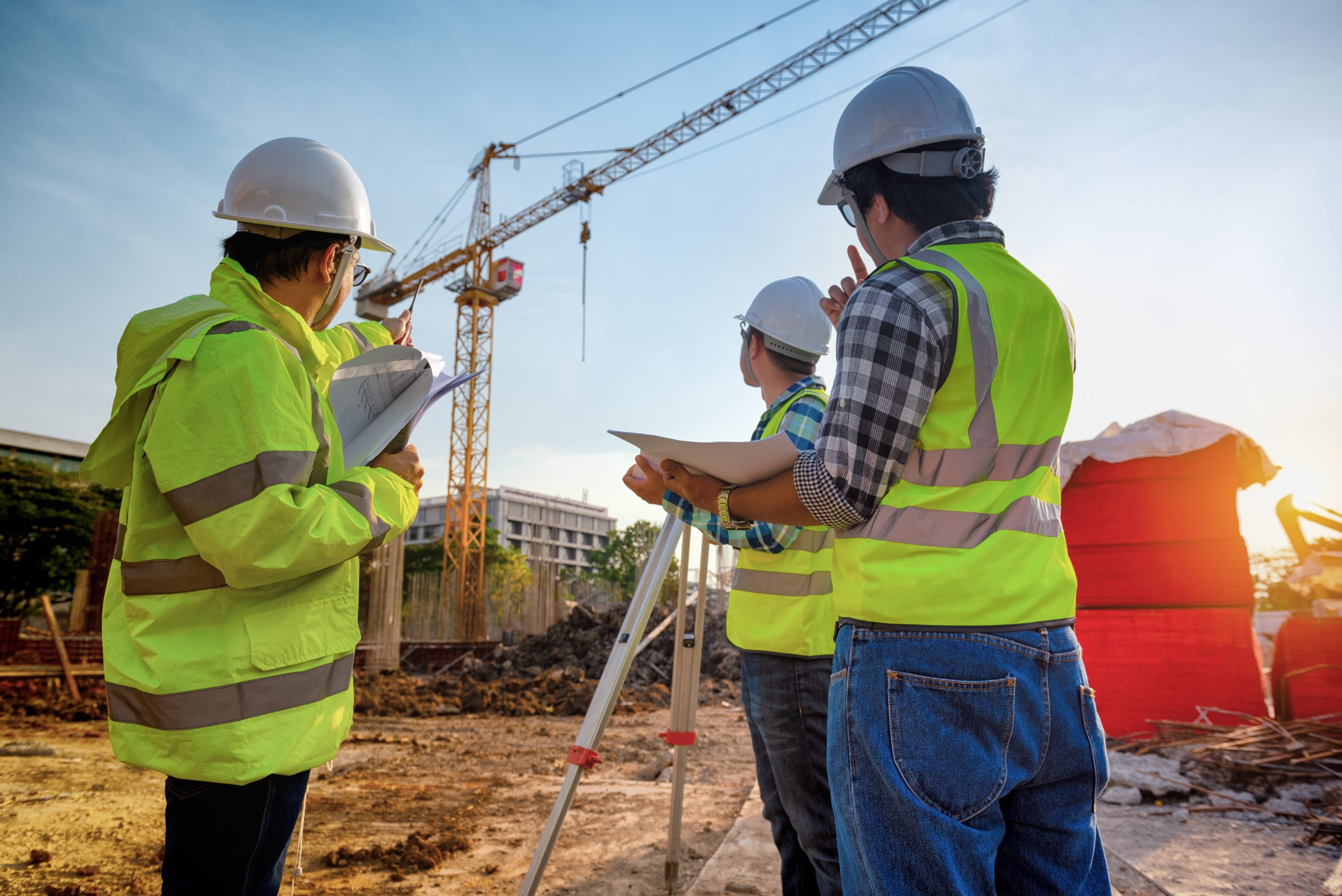 Construction engineers discussion with architects at construction site or building site of highrise building with Surveying for making contour plans is a graphical representation of the lay in land.